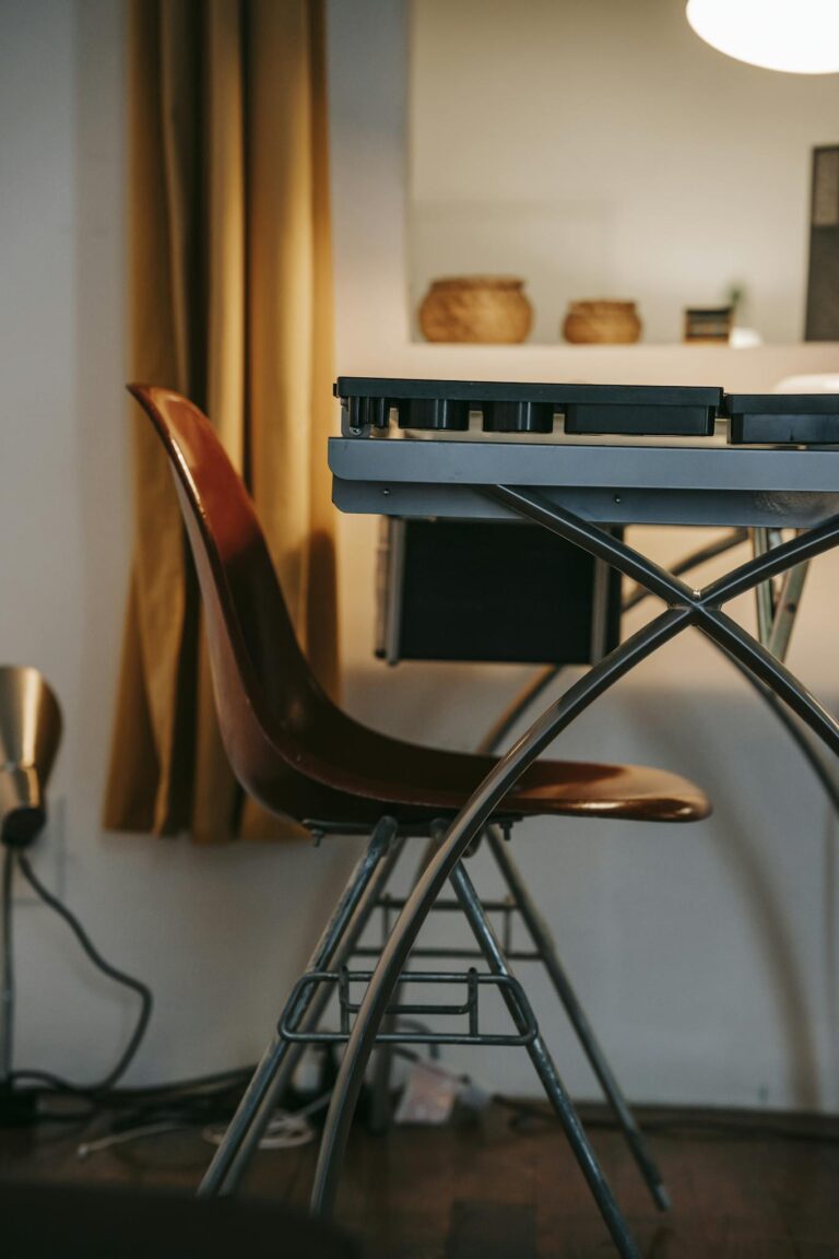 A contemporary room featuring a sleek chair and desk in a warm setting, perfect for creative work.